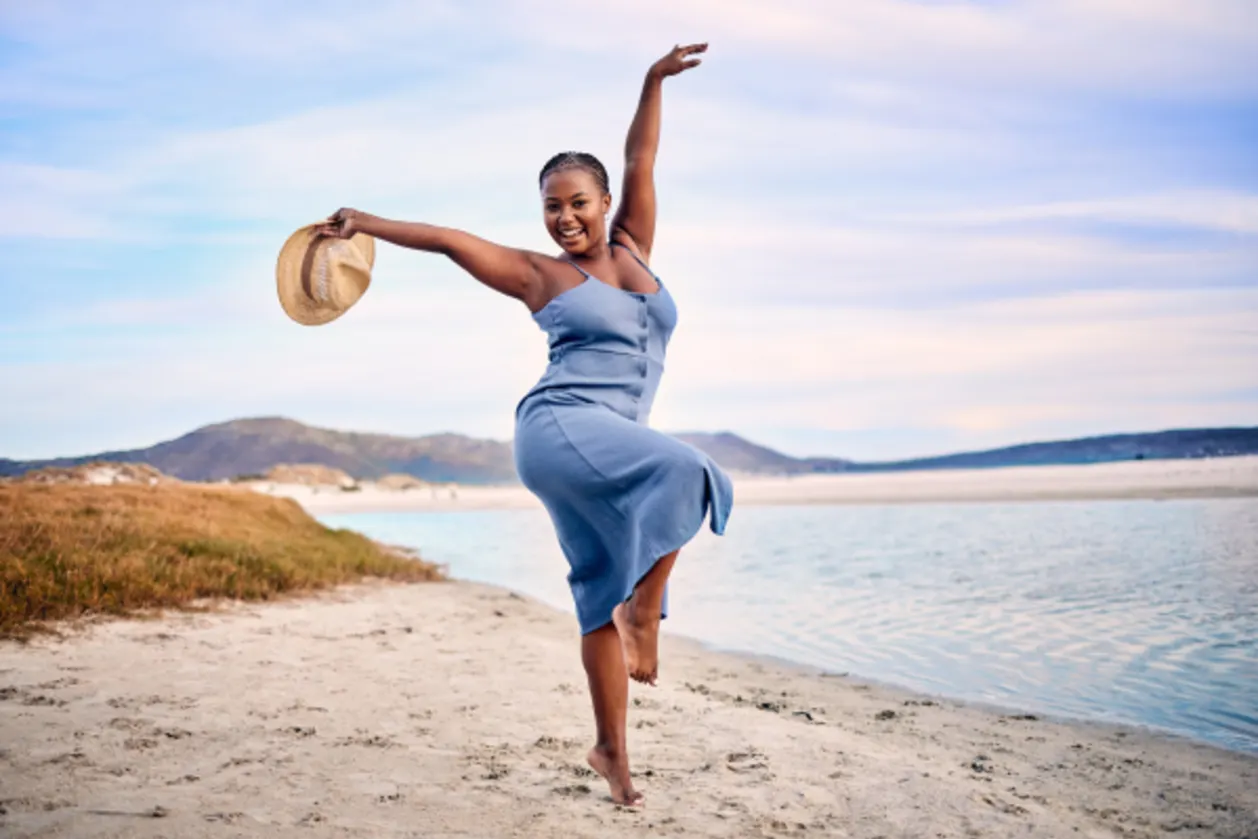 Happy woman traveler on beach